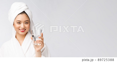 Healthy young beautiful woman drinking water, beauty face natural makeup, isolated over white background. Healthy young beautiful woman drinking water, beauty face natural makeup, isolated over white background. 89725388