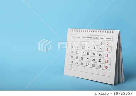 Paper calendar on light blue background, space for text. Planning concept 89725557