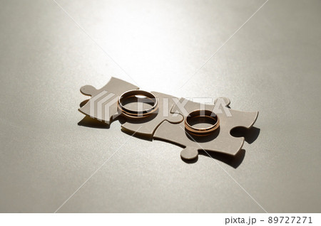 Wedding rings and puzzle pieces. Husband and wife complement each other perfectly. 89727271