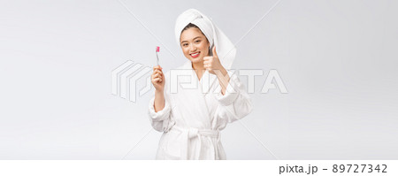Asian happy woman with toothbrush in bathrobe morning mood 89727342