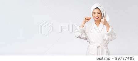 Asian happy woman with toothbrush in bathrobe morning mood 89727485