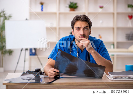 Young male doctor radiologist working in the clinic Young male doctor radiologist working in the clinic 89728905