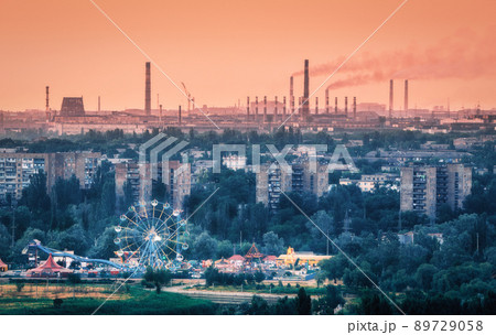 Amusement park with ferris wheel and buildings in Mariupol Amusement park with ferris wheel and buildings in Mariupol 89729058