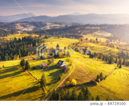 Aerial view of beautiful village in mountains at sunset Aerial view of beautiful village in mountains at sunset 89729100