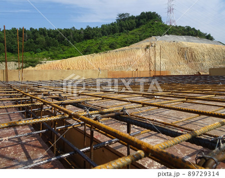 SELANGOR, MALAYSIA -MAY 3, 2022: Steel reinforcement bars for reinforced concrete construction have started to rust after being exposed to weather and water vapor. It can affect rebar if left untreate 89729314