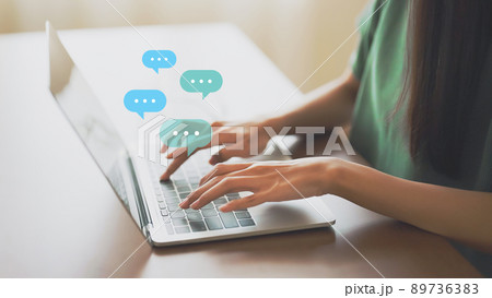 Woman using computer laptop on wood desk 89736383