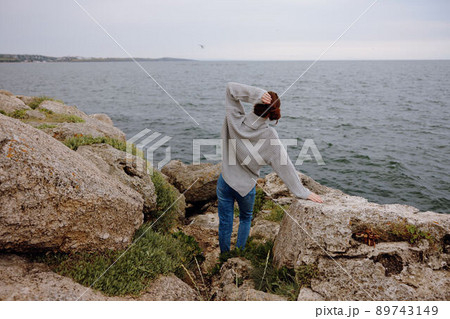 beautiful woman nature rocks coast landscape Ocean female relaxing 89743149