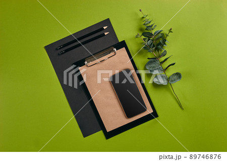 Top view in focus with different office equipment, supplies, stationery. Green background with copy space. Education, workplace concept. Close-up. Top view in focus with different office equipment, supplies, stationery. Green background with copy space. Education, workplace concept. Close-up. 89746876