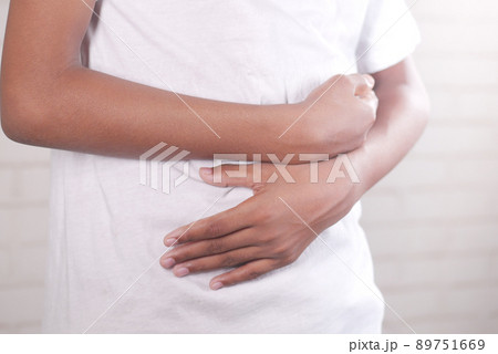 teenage boy suffering stomach pain close up. 89751669