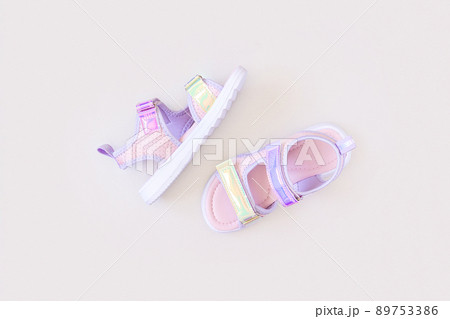 Stylish holographic sandals for kids on grey background. Shiny fashion summer shoes. Flat lay, Top view 89753386