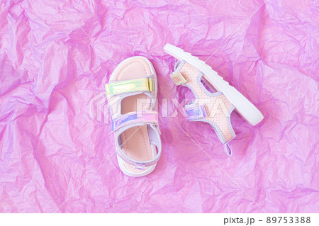 Stylish holographic sandals for kids on purple background. Shiny fashion summer shoes. Flat lay, Top view 89753388