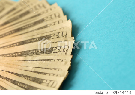 Big amount of old twenty dollar bills on blue background. Money earnings, payday or tax paying period Big amount of old twenty dollar bills on blue background. Money earnings, payday or tax paying period 89754414