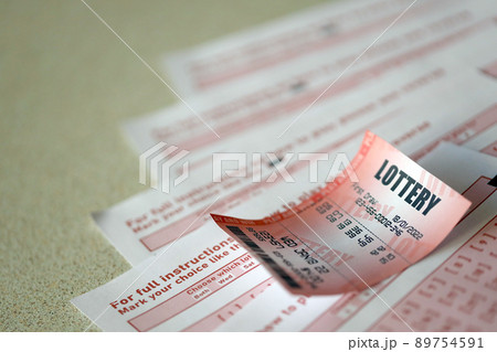 Red lottery ticket lies on pink gambling sheets with numbers for marking to play lottery. Lottery playing concept or gambling addiction. Close up Red lottery ticket lies on pink gambling sheets with numbers for marking to play lottery. Lottery playing concept or gambling addiction. Close up 89754591