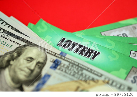 Close up view of green lottery scratch cards and us dollar bills. Many used fake instant lottery tickets with gambling results. Gambling addiction Close up view of green lottery scratch cards and us dollar bills. Many used fake instant lottery tickets with gambling results. Gambling addiction 89755126