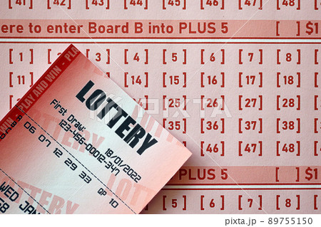 Red lottery ticket lies on pink gambling sheets with numbers for marking to play lottery. Lottery playing concept or gambling addiction. Close up Red lottery ticket lies on pink gambling sheets with numbers for marking to play lottery. Lottery playing concept or gambling addiction. Close up 89755150