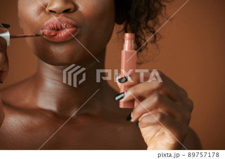 Woman Applying Matte Lipstick 89757178