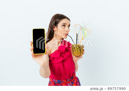 Beautiful young brunette woman drinking pineapple cocktail 89757990