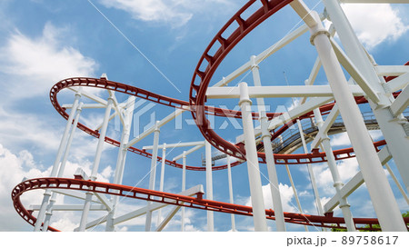 red roller coaster in a amusement park in sunny day red roller coaster in a amusement park in sunny day 89758617