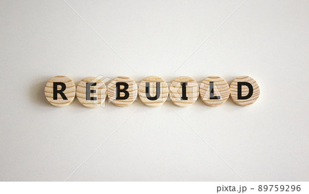 Rebuild and build symbol. The concept word Rebuild on wooden circles. Beautiful white background, copy space. Business rebuild and build concept. 89759296