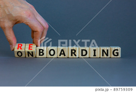 Onboarding or reboarding symbol. Businessman turns wooden cubes and changes words Onboarding to Reboarding. Beautiful grey table grey background. Business onboarding or reboarding concept. Copy space. Onboarding or reboarding symbol. Businessman turns wooden cubes and changes words Onboarding to Reboarding. Beautiful grey table grey background. Business onboarding or reboarding concept. Copy space. 89759309