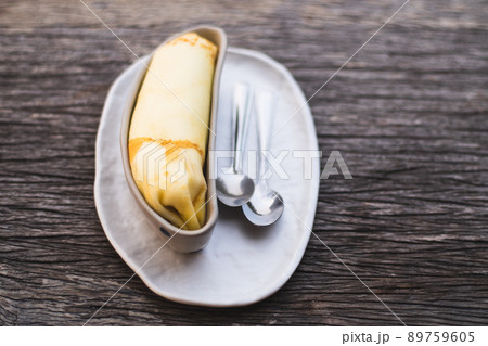 Banana crepe sweet dessert object still life. The crepe put in the ceramic container bowl banana shape form design. Banana crepe sweet dessert object still life. The crepe put in the ceramic container bowl banana shape form design. 89759605