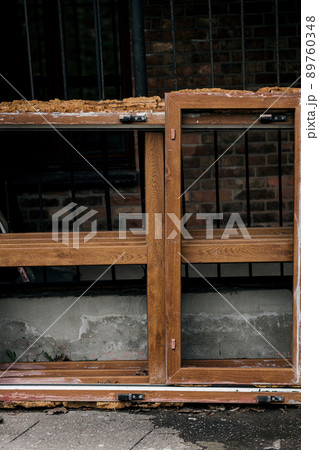 broken old window next to a ruined house 89760348