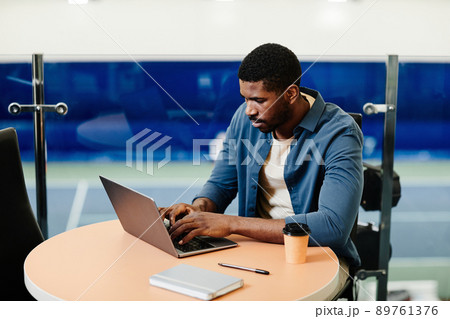 Man Using Laptop at Sports Club Man Using Laptop at Sports Club 89761376