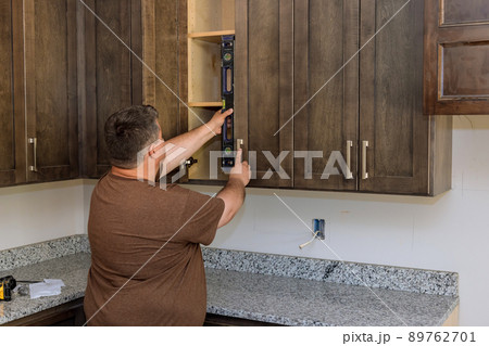 Checks level of adjusting the correct installation of the cabinet, kitchen Checks level of adjusting the correct installation of the cabinet, kitchen 89762701