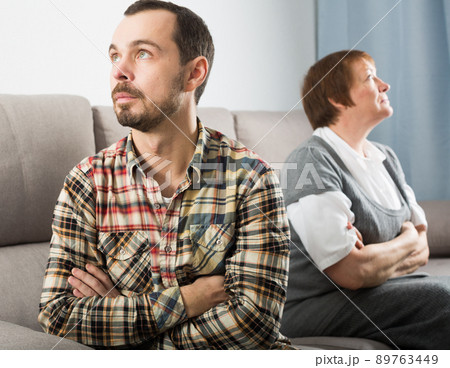 Elderly mother and son quarrel 89763449