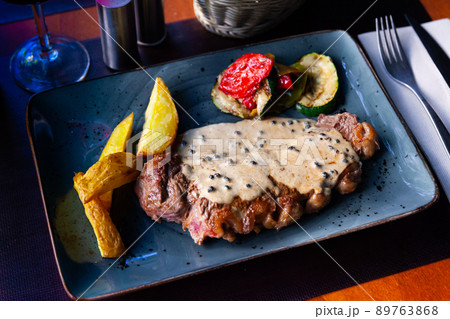 Delicious grilled beef steak with potatoes and vegetables Delicious grilled beef steak with potatoes and vegetables 89763868