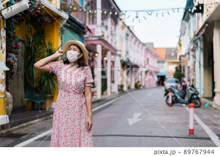 Travelers with mask walking on street Phuket old town with Building Sino Portuguese architecture at Phuket Old Town area Phuket, Thailand. Travel concept and summer trip. Travelers with mask walking on street Phuket old town with Building Sino Portuguese architecture at Phuket Old Town area Phuket, Thailand. Travel concept and summer trip. 89767944