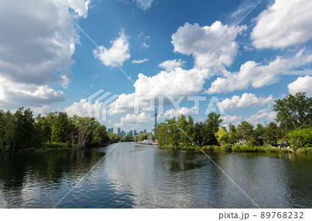 The skyline of Toronto, a view from the lake side - Toronto, Ontario, Canada. Panorama view of the Canadian city of Toronto, with white clouds on a blue sky with the Toronto tower. Urban view of city 89768232