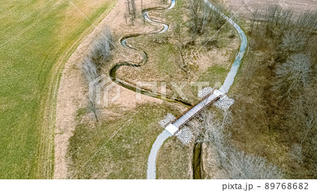 Aerial view in springtime with a trail and spiraling river Aerial view in springtime with a trail and spiraling river 89768682