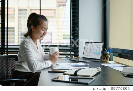 Business accountant asian woman analysis financial report at her office Business accountant asian woman analysis financial report at her office 89770809