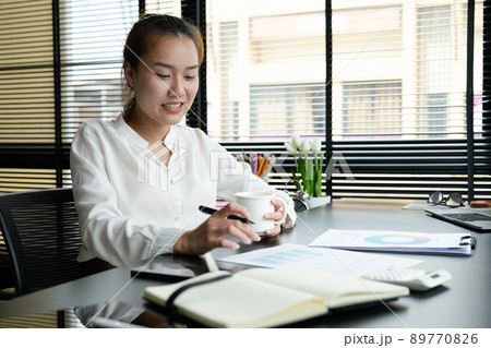 Business accountant asian woman analysis financial report at her office 89770826