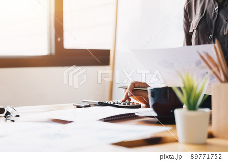 Close up Business woman using calculator and laptop for do math finance  89771752