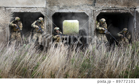 Five special forces soldiers during a special operation at the exit from the tunnel. Five special forces soldiers during a special operation at the exit from the tunnel. 89772101