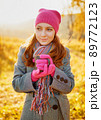 Young woman enjoying the fall season. Autumn outdoor portrait 89772123