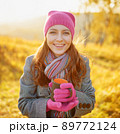 Young woman enjoying the fall season. Autumn outdoor portrait 89772124