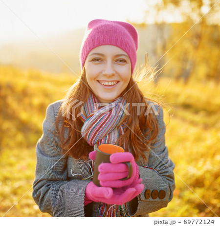 Young woman enjoying the fall season. Autumn outdoor portrait Young woman enjoying the fall season. Autumn outdoor portrait 89772124