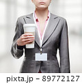 Business woman with a tumbler of coffee 89772127