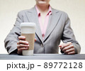Business woman with a tumbler of coffee 89772128