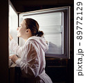 Young woman looking for some snack in fridge late at night 89772129