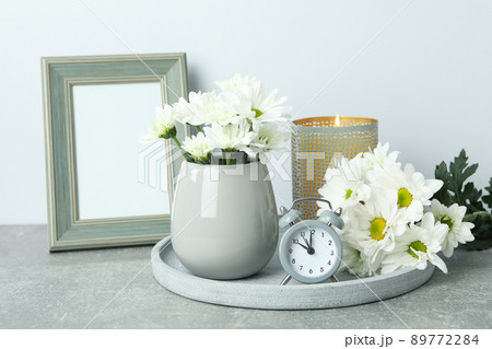 Beautiful composition with white chrysanthemums on gray textured table 89772284