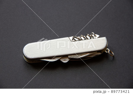 Metallic swiss knife isolated on black Metallic swiss knife isolated on black 89773421