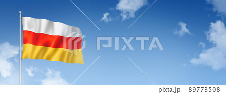 South Ossetia flag isolated on a blue sky. Horizontal banner 89773508