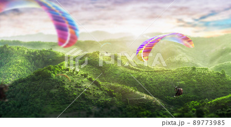 Paragliding multicolor. Paraglider flying over Landscape from the background Beauty nature mountain landscape of the sky. 89773985