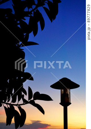 Silhouette of street lamp with sunset sky 89777829