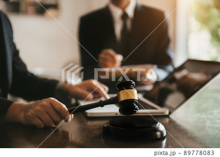 Business people and lawyers discussing contract papers sitting in the table at office in the morning. concepts of law, advice, legal services. Business people and lawyers discussing contract papers sitting in the table at office in the morning. concepts of law, advice, legal services. 89778083
