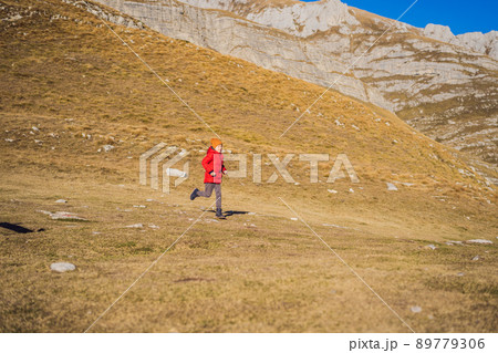 Montenegro. Boy tourist on the background of Durmitor National Park. Saddle Pass. Alpine meadows. Mountain landscape. Travel around Montenegro concept 89779306
